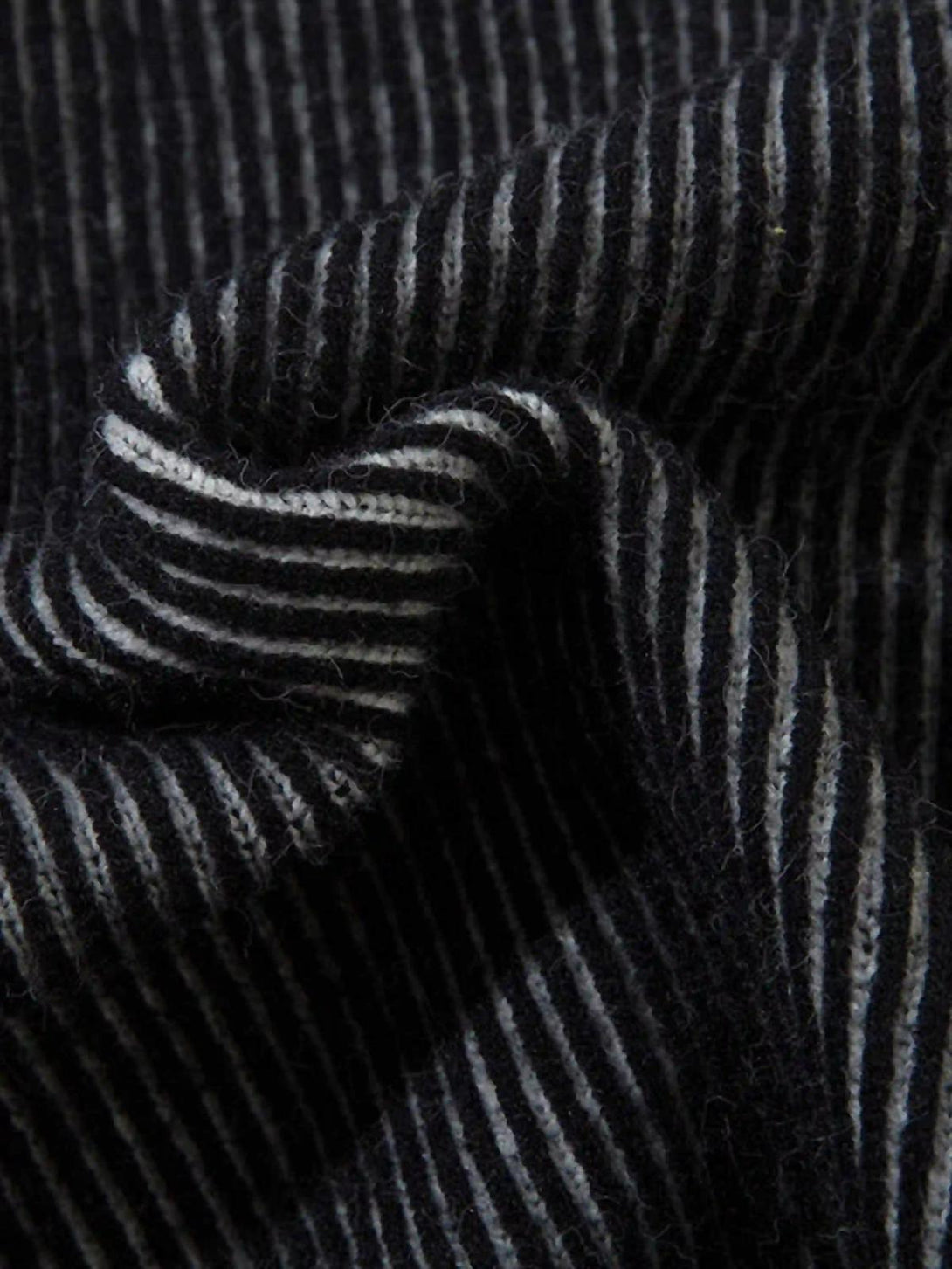 Striped texture detail from TALISHKO jacquard half turtleneck sweater, emphasizing fabric quality.