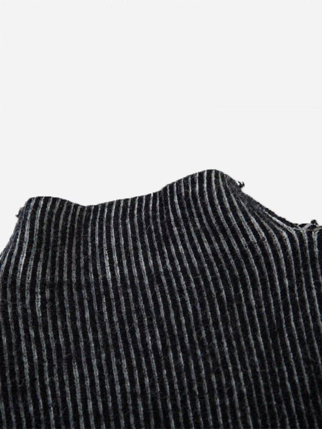 "Zoomed-in view of TALISHKO jacquard half turtleneck sweater, showcasing its striped fabric texture."