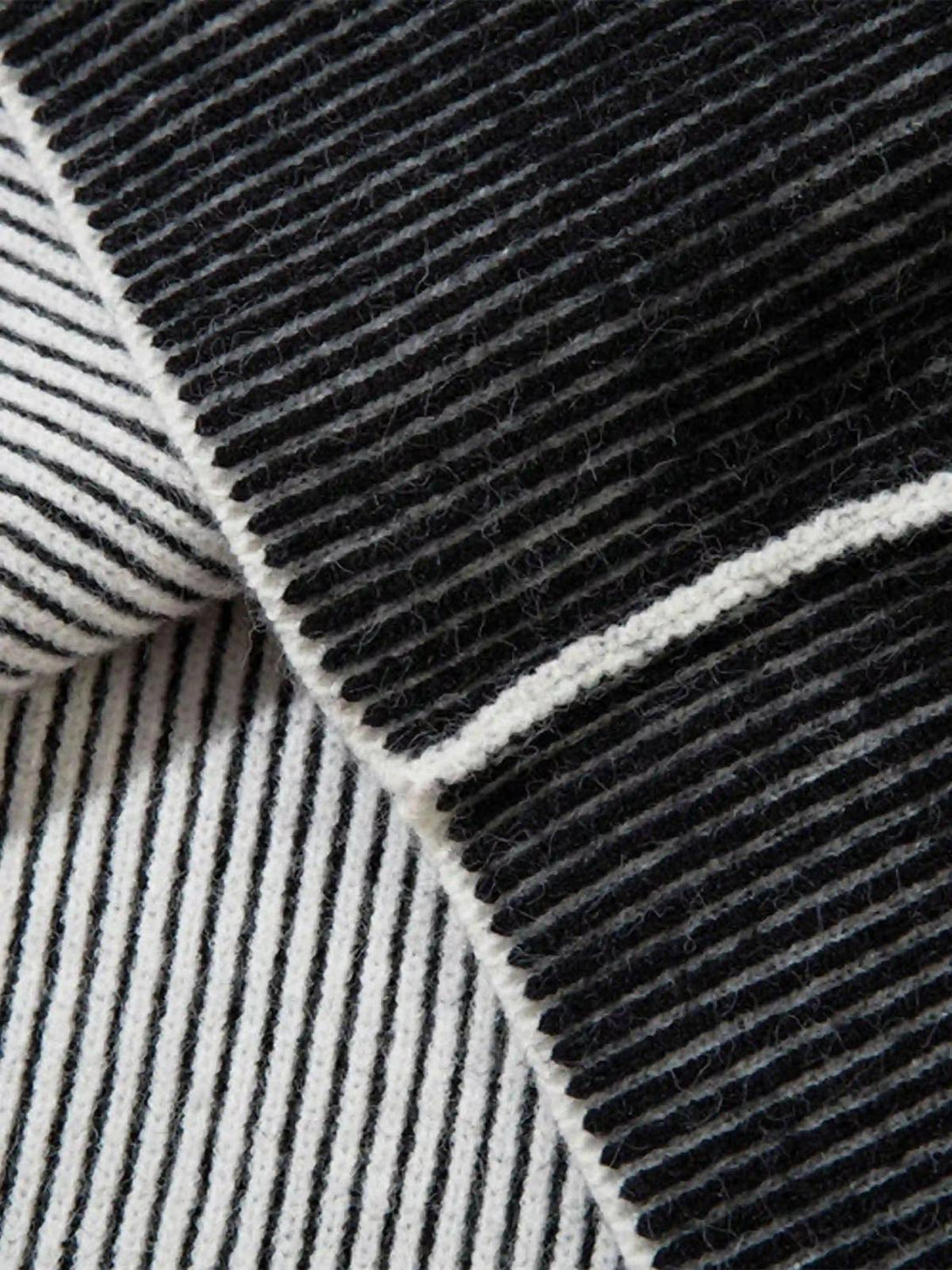 Texture and pattern showcased in TALISHKO jacquard half turtleneck sweater's striped fabric.