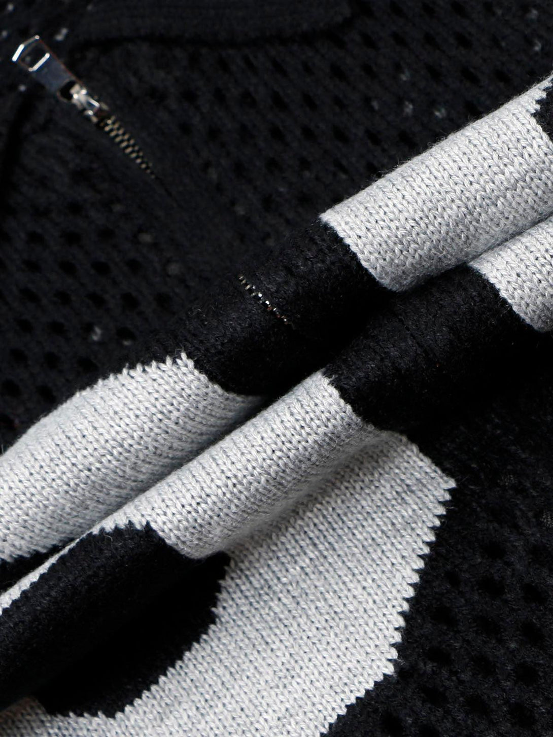 Focusing on the intricate texture of the TALISHKO jacquard mesh knit zipper polo sweater.