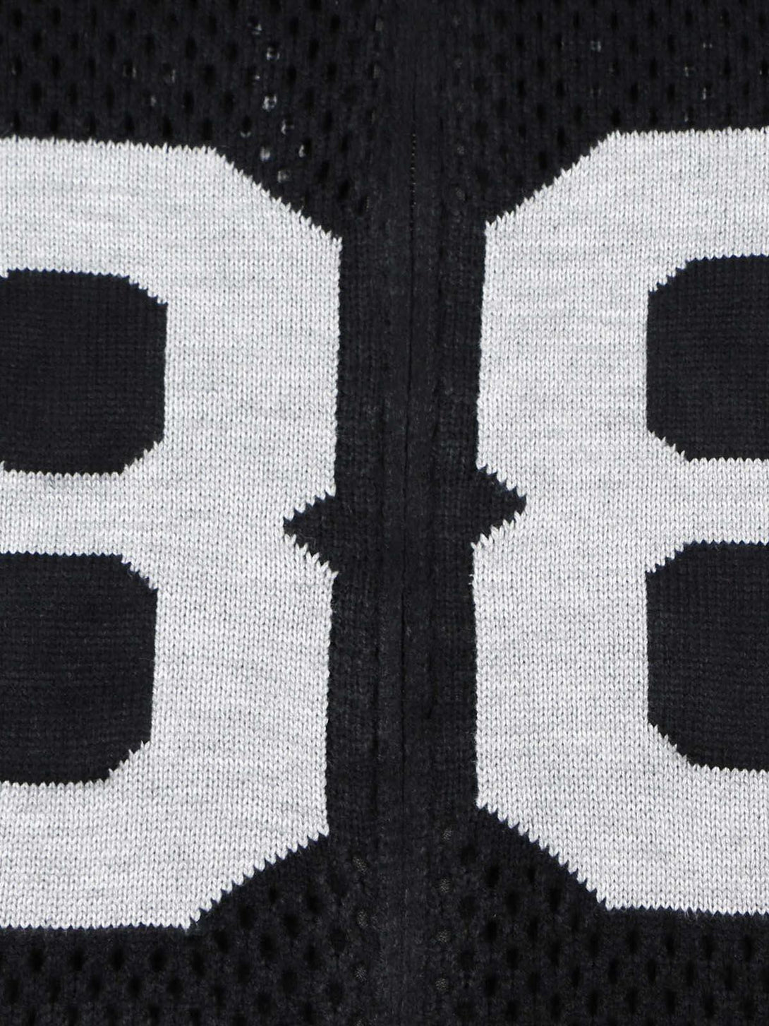 A tight crop highlighting the "88" design on the TALISHKO jacquard mesh knit sweater.