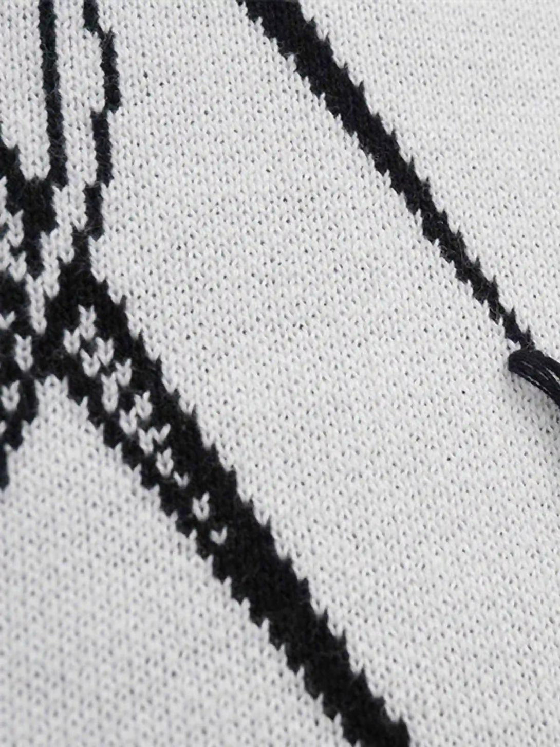 Intricate look at the jacquard thorns design on a TALISHKO sweater, showcasing fine detail.