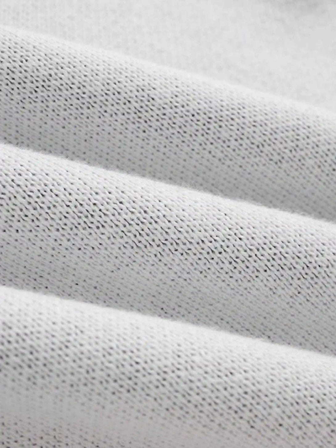 Zoomed-in texture of a jacquard thorns tassel sweater by TALISHKO, highlighting intricate weaving.