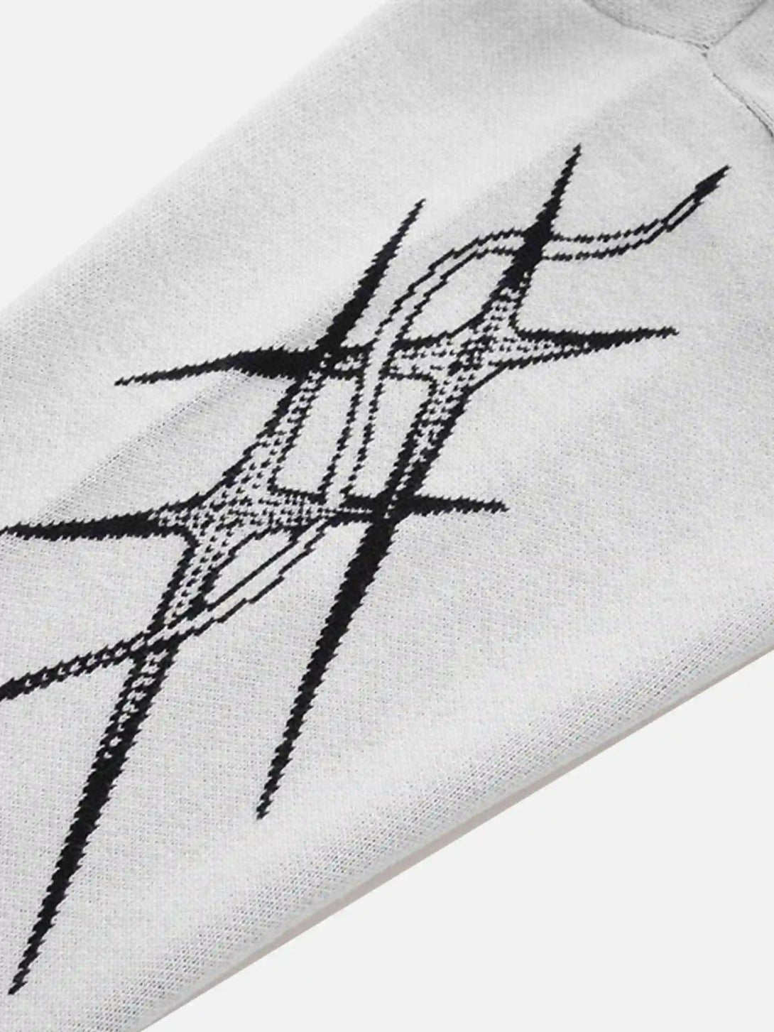 A tight crop highlighting the jacquard thorns design on a TALISHKO sweater, emphasizing detail.