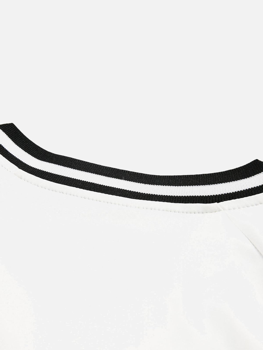 A close-up of the neckline detail on a TALISHKO jersey, showcasing contrast color stitching.