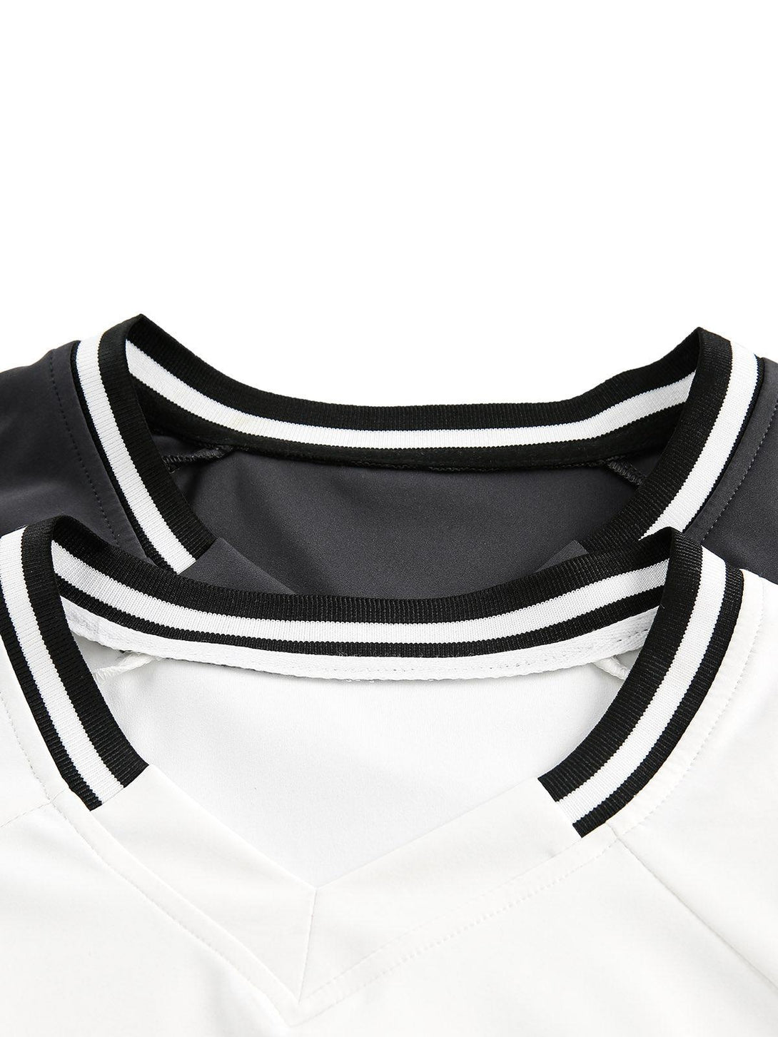 A detailed look at the neckline of a TALISHKO jersey, featuring contrast color stitching.