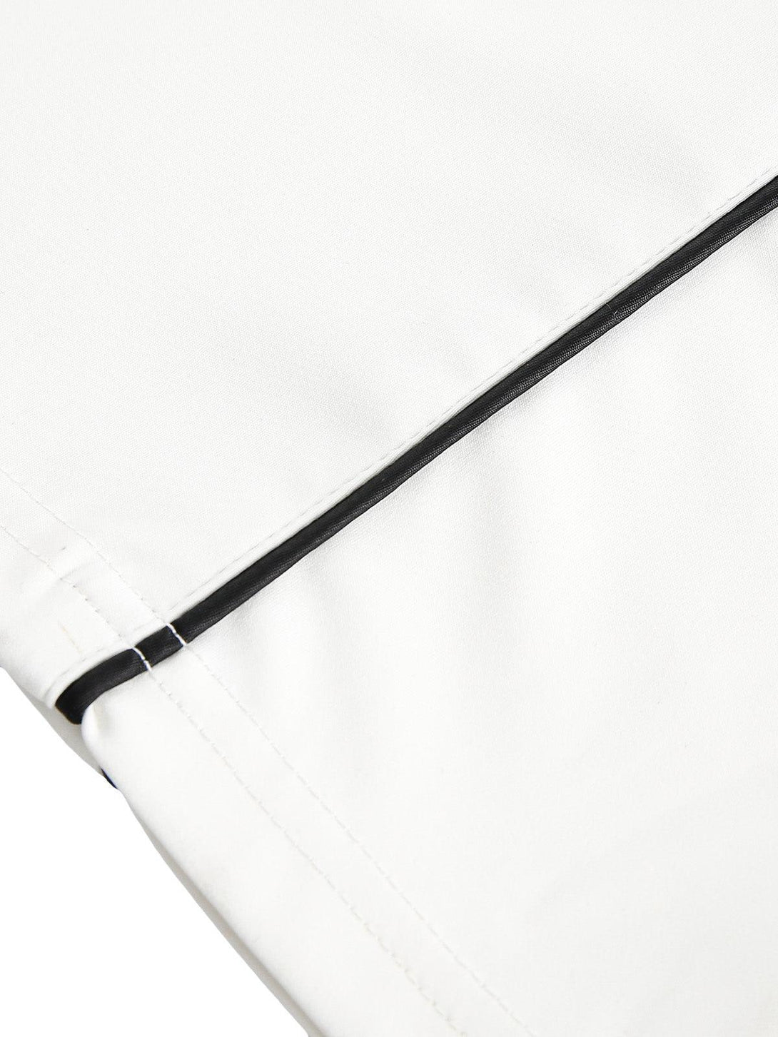 Detailed fabric and stitching on a TALISHKO jersey, highlighting contrast color design.