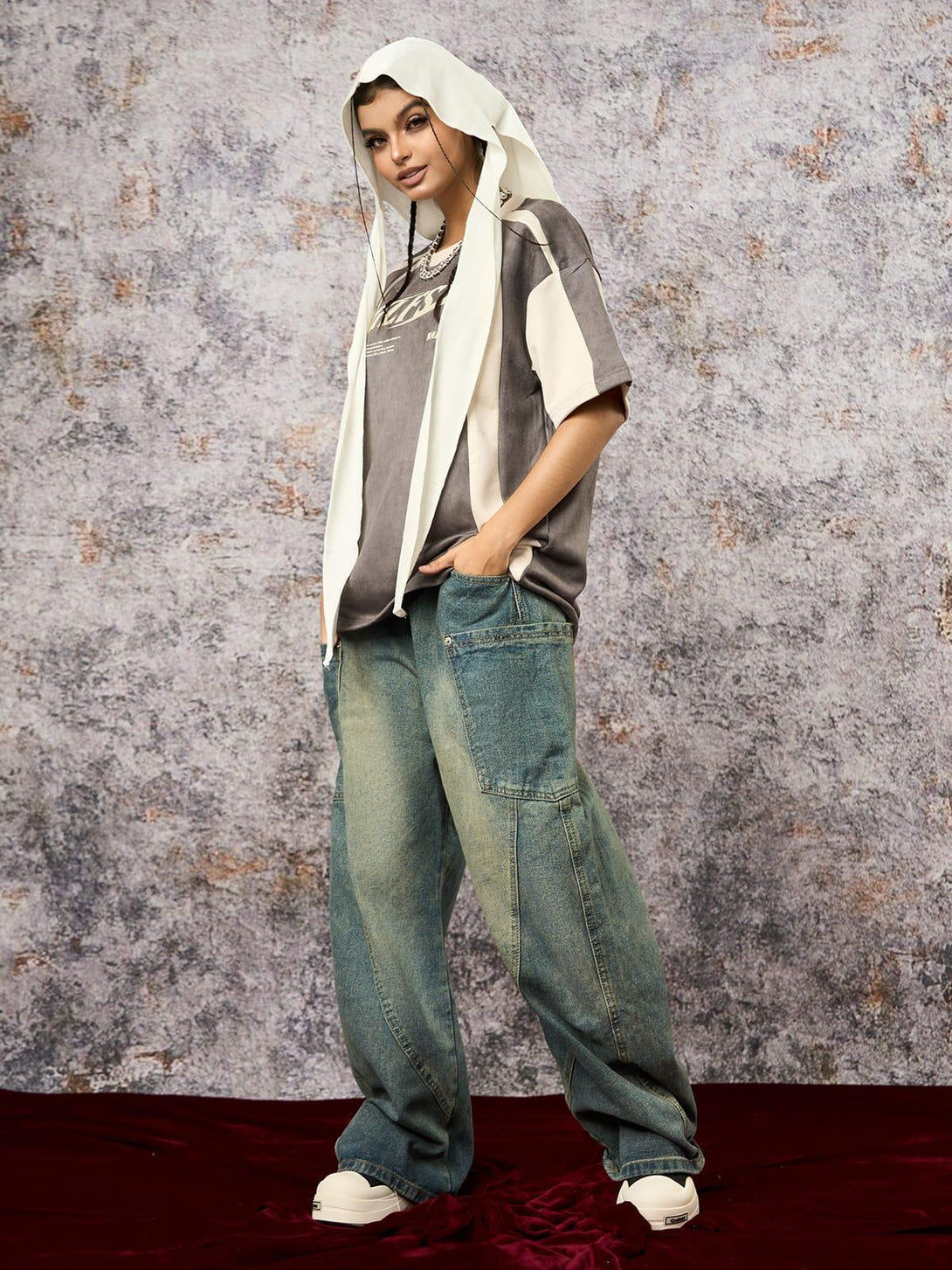 Model in TALISHKO's deconstructed T-shirt with contrast stitching, paired with relaxed denim.