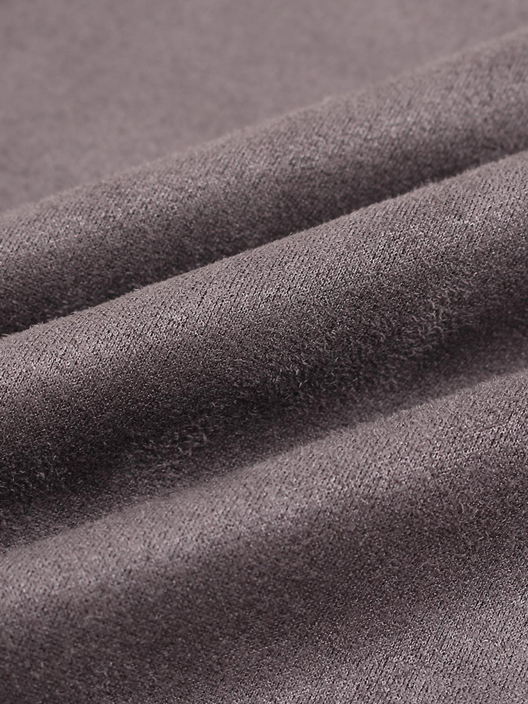 Zoomed-in texture of TALISHKO T-shirt fabric, showcasing intricate contrast stitching.