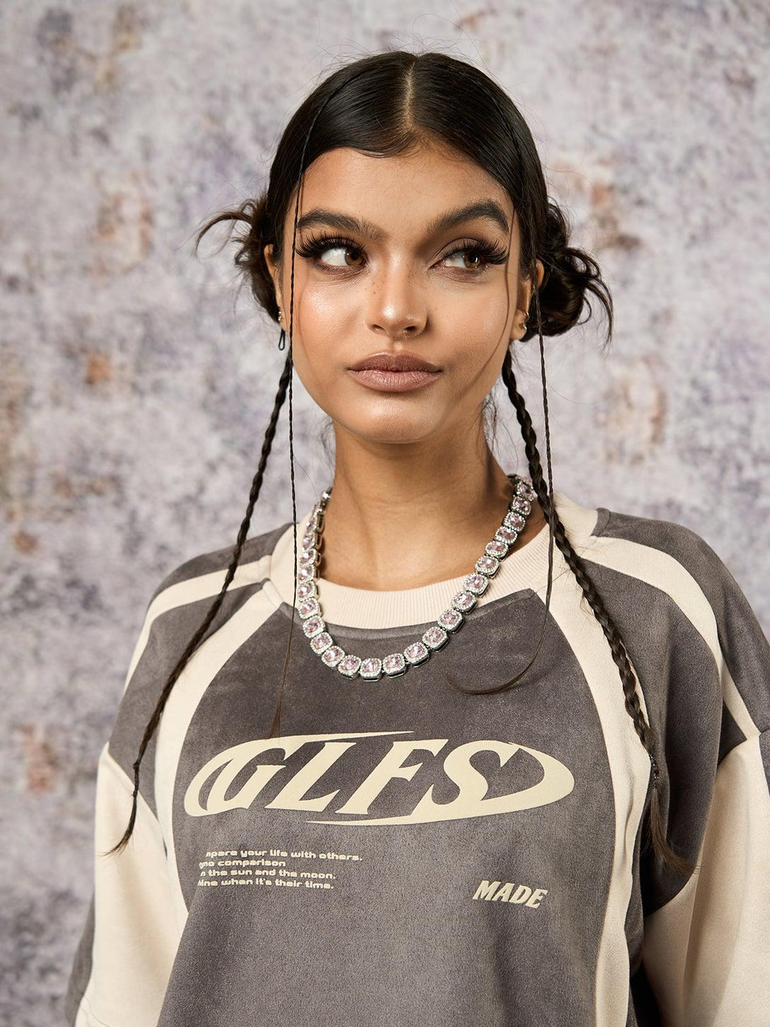 Model showcasing a TALISHKO T-shirt with deconstructed design and contrast stitching details.