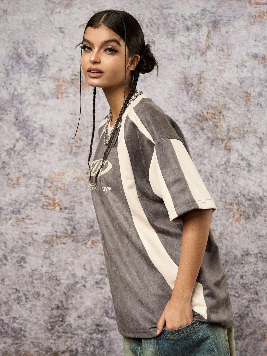 Model wearing TALISHKO's deconstructed T-shirt, featuring contrast stitching and casual flair.