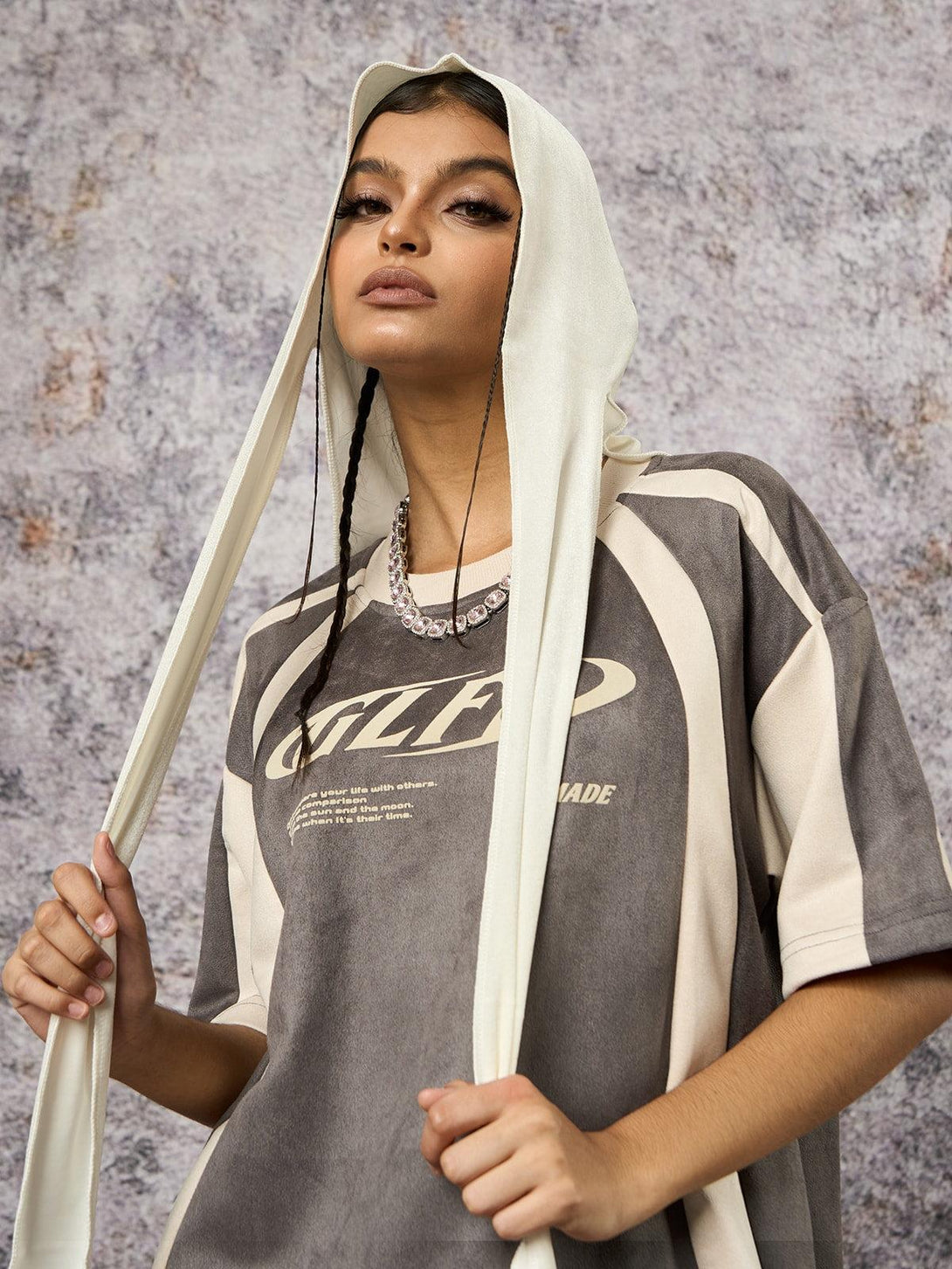 Model styled in a TALISHKO deconstructed T-shirt, featuring unique stitching and print design.