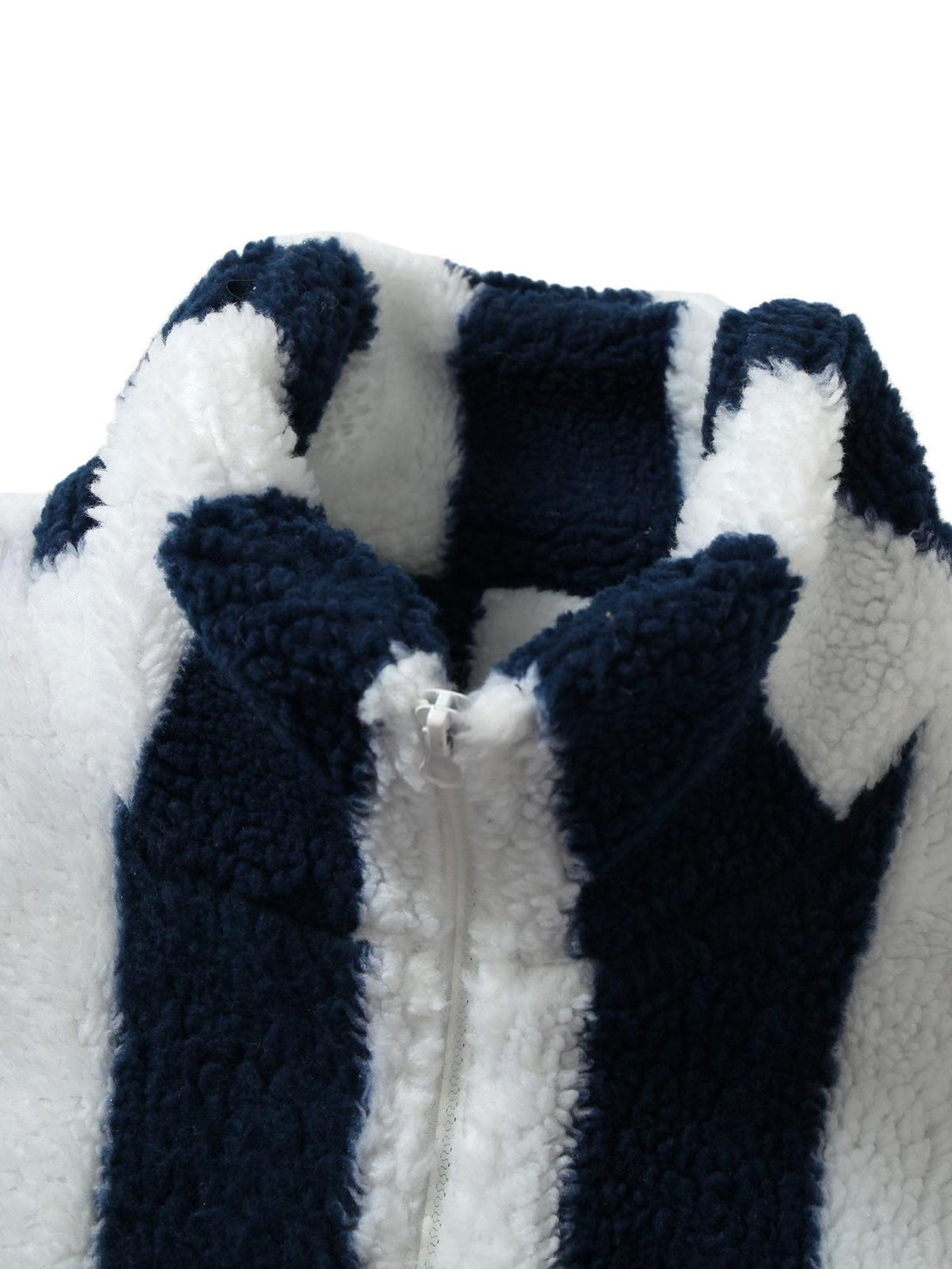 Close-up of TALISHKO's striped sherpa jacket, highlighting the soft texture and zipper detail.