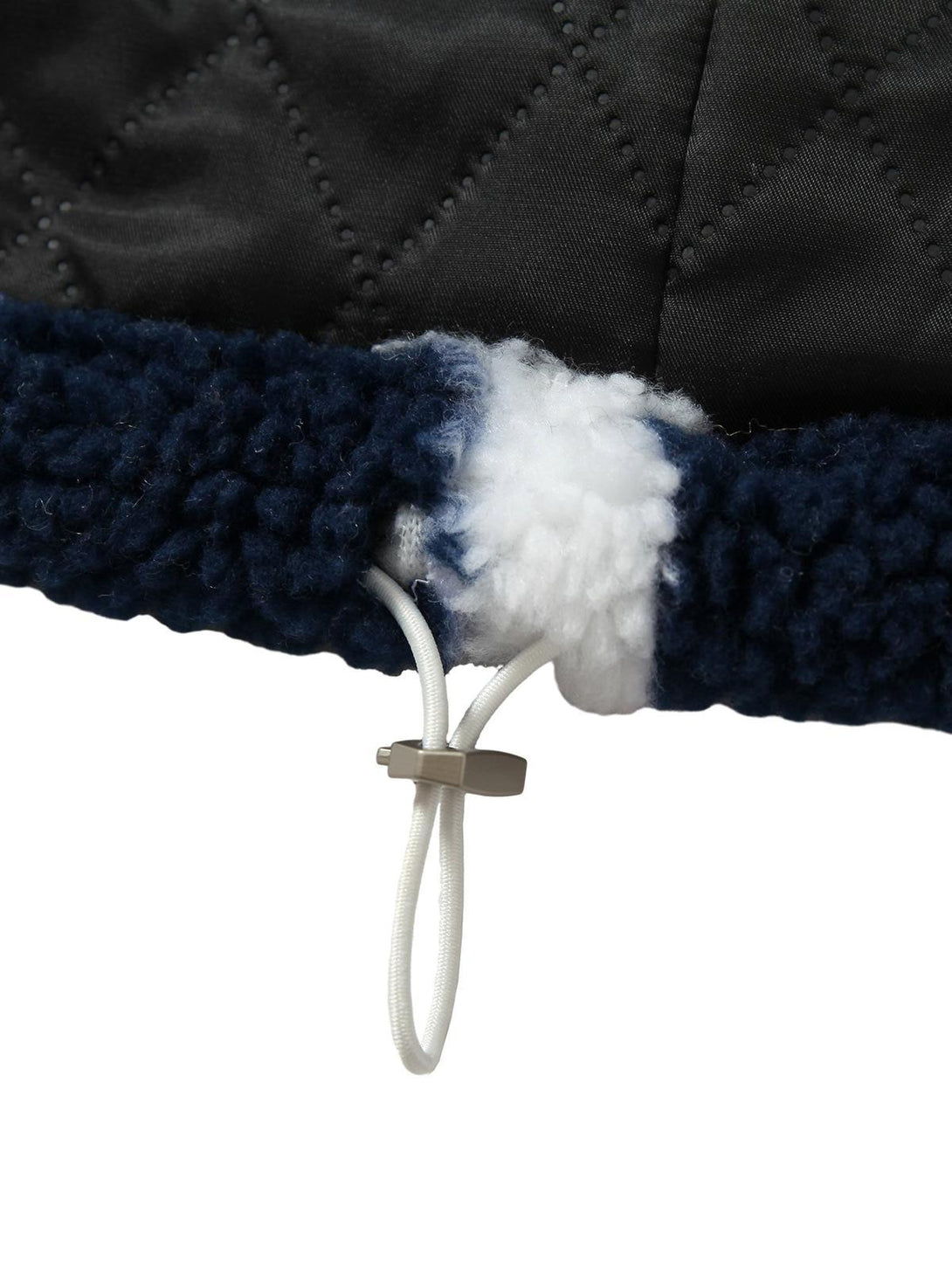 A close-up of TALISHKO's sherpa jacket, highlighting the drawstring and quilted detail.