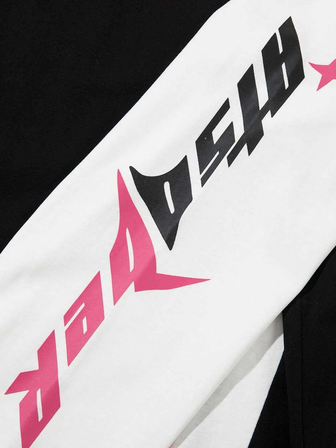 Detailed fabric and design of TALISHKO jersey, highlighting bold pink and black graphics.