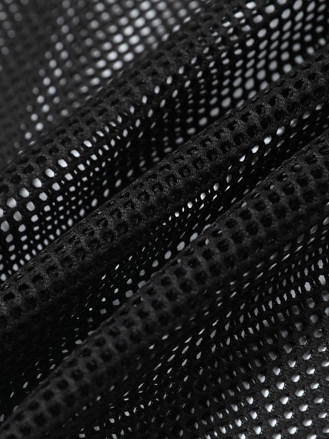 Zoomed-in texture of TALISHKO's black mesh fabric, highlighting intricate design details.