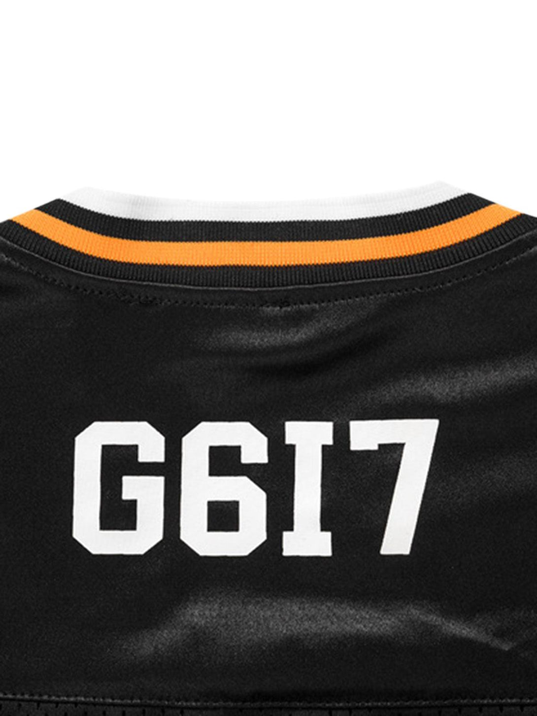 Zoomed-in detail of TALISHKO's oversized V-neck jersey T-shirt, highlighting bold white lettering.