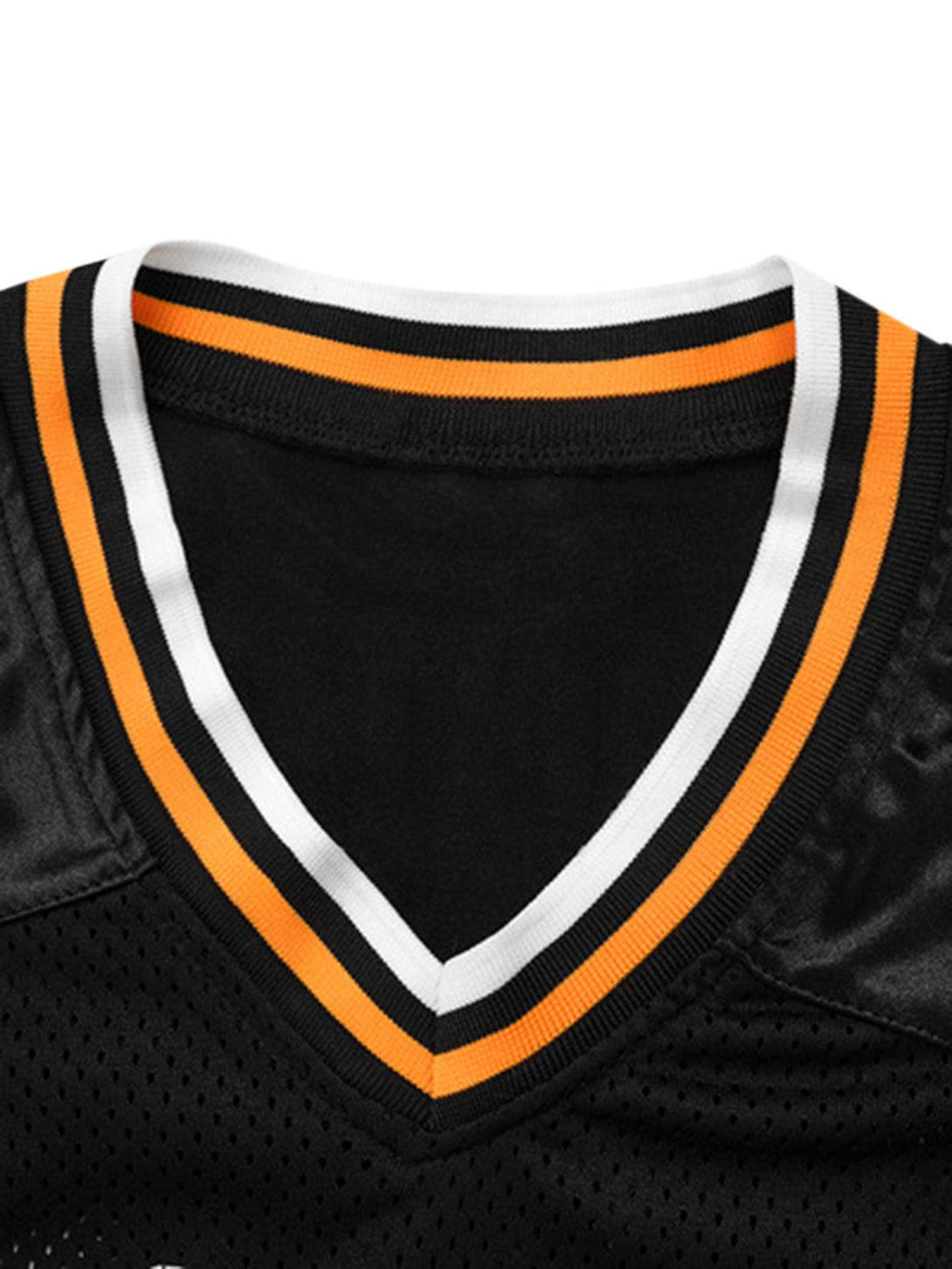 A detailed view of TALISHKO's oversized V-neck T-shirt, highlighting black, white, and orange trim.