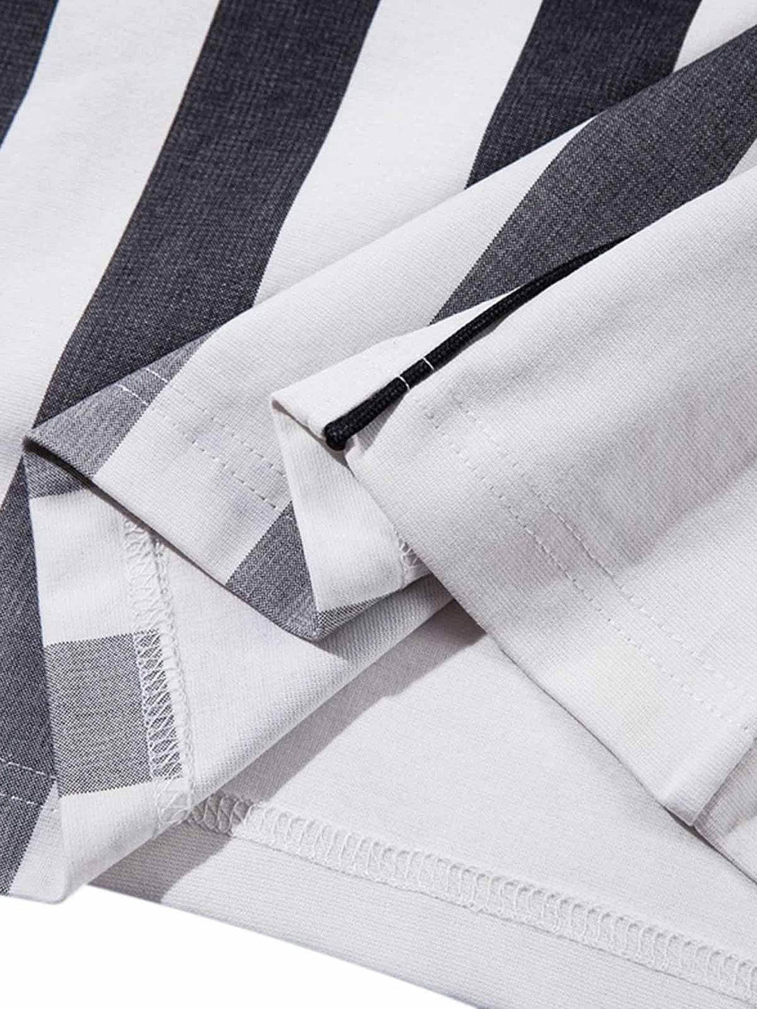 Detailed fabric and stitching on TALISHKO's striped jersey polo shirt, highlighting quality craftsmanship.