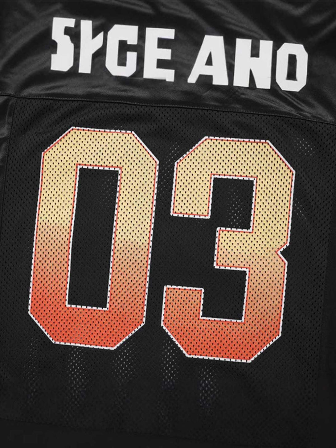 Zoomed-in view of TALISHKO's black jersey T-shirt with bold "03" print, highlighting sporty style.