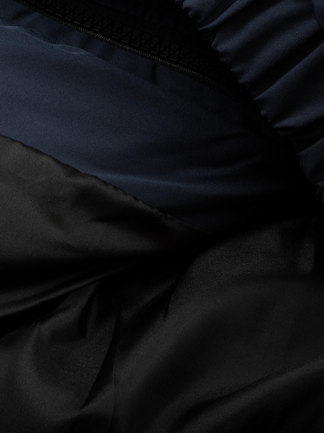 Texture and pattern showcased on a quilted puffer jacket by TALISHKO, emphasizing fabric detail.