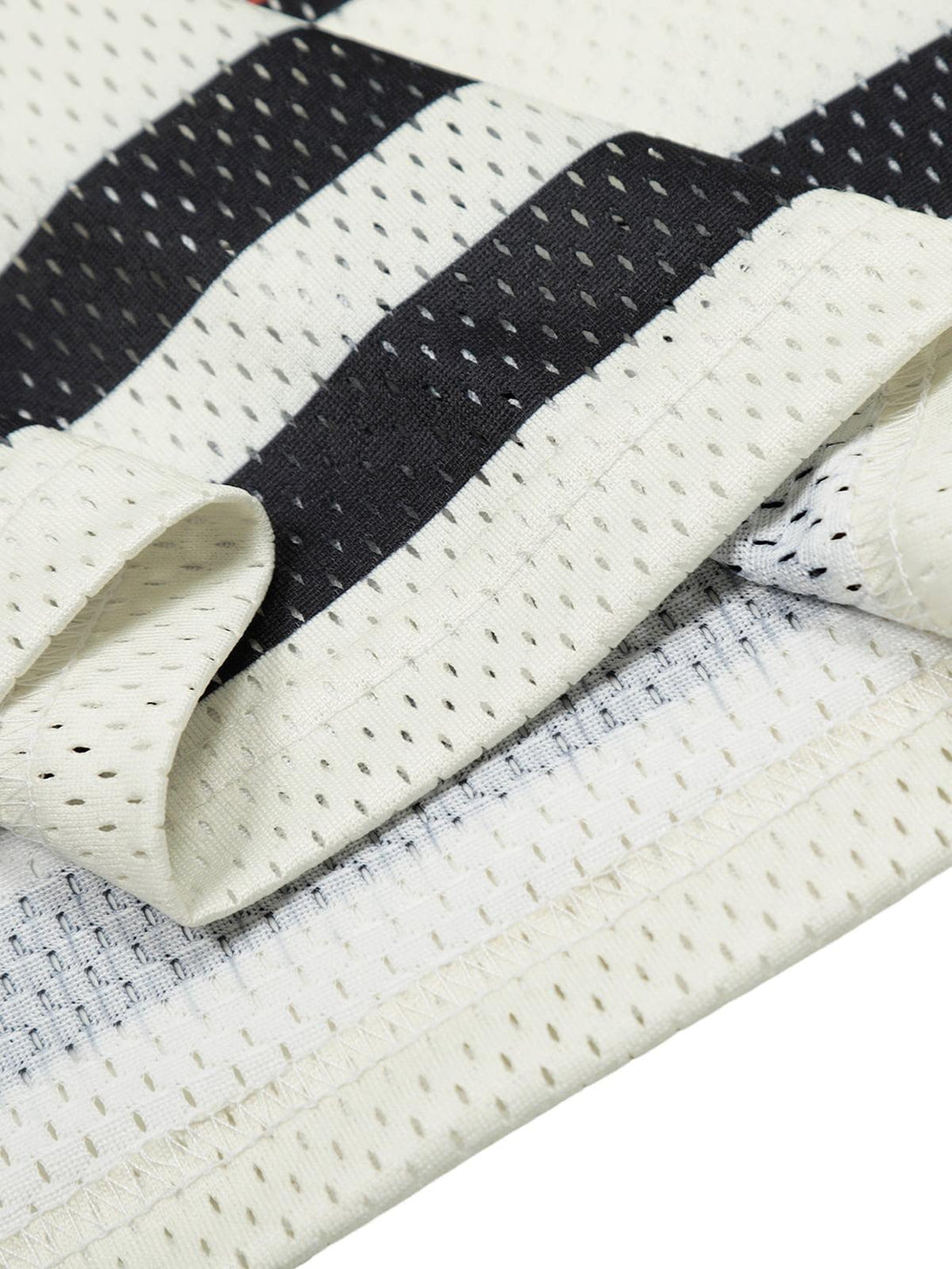 A close-up of the breathable mesh fabric on a TALISHKO jersey-style T-shirt, showcasing texture.