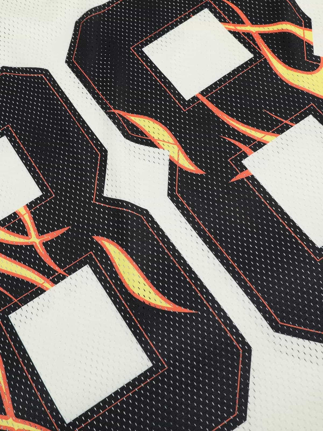 Zoomed-in view of flame-patterned numbers on a TALISHKO jersey-style T-shirt.