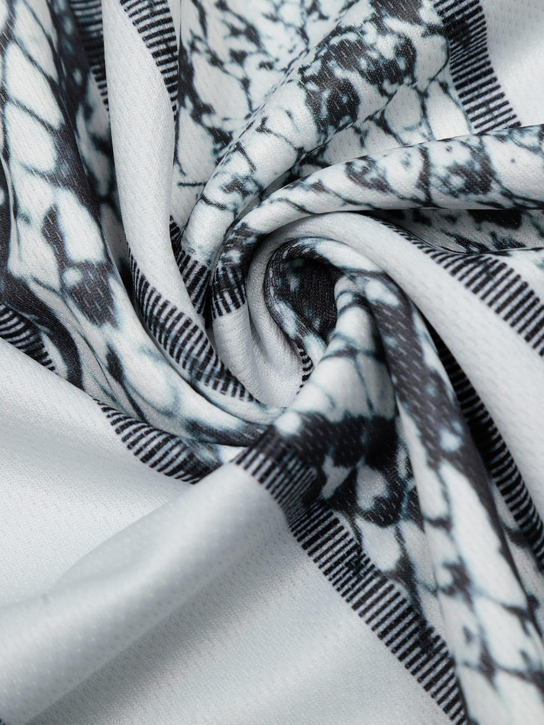 Intricate look at TALISHKO's jersey-style T-shirt showcasing its snake print texture.