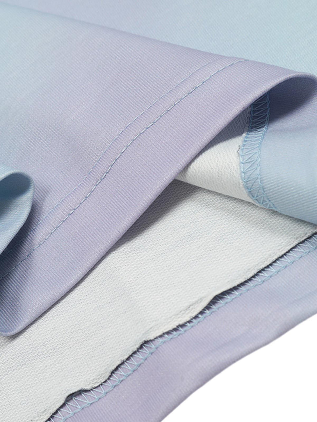 Intricate look at TALISHKO's tie-dye jersey fabric, highlighting pastel hues and stitching.
