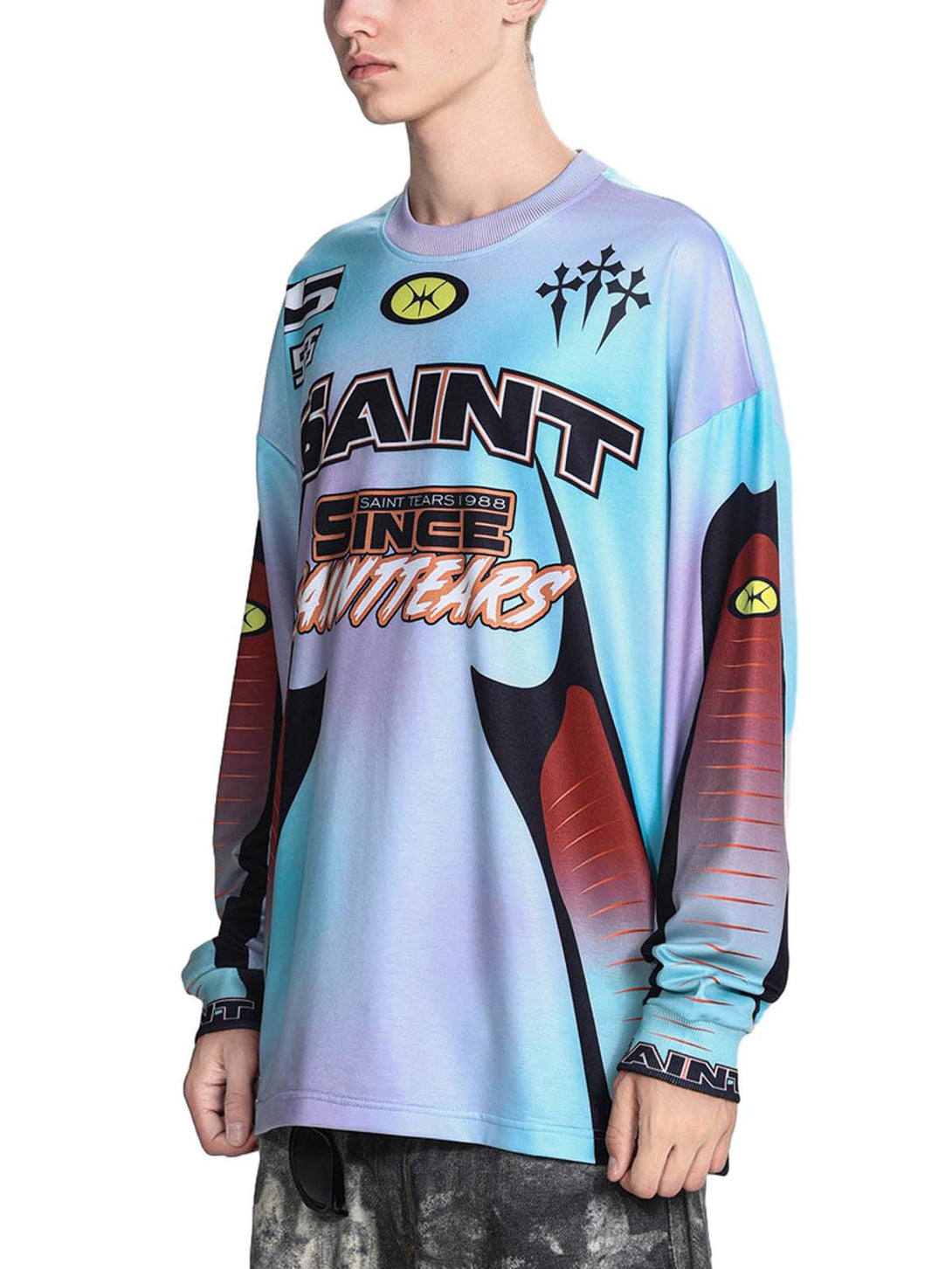 A side view of TALISHKO's tie-dye long-sleeve jersey T-shirt with dynamic graphic patterns.