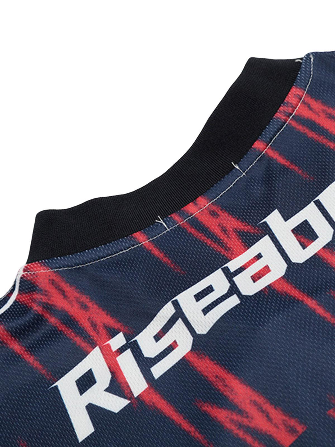 A close-up of the TALISHKO jersey's neckline, showcasing the vibrant red and navy pattern.