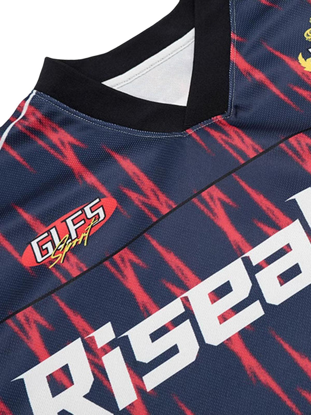 Close-up of TALISHKO jersey's vibrant red and navy pattern with bold text detail.