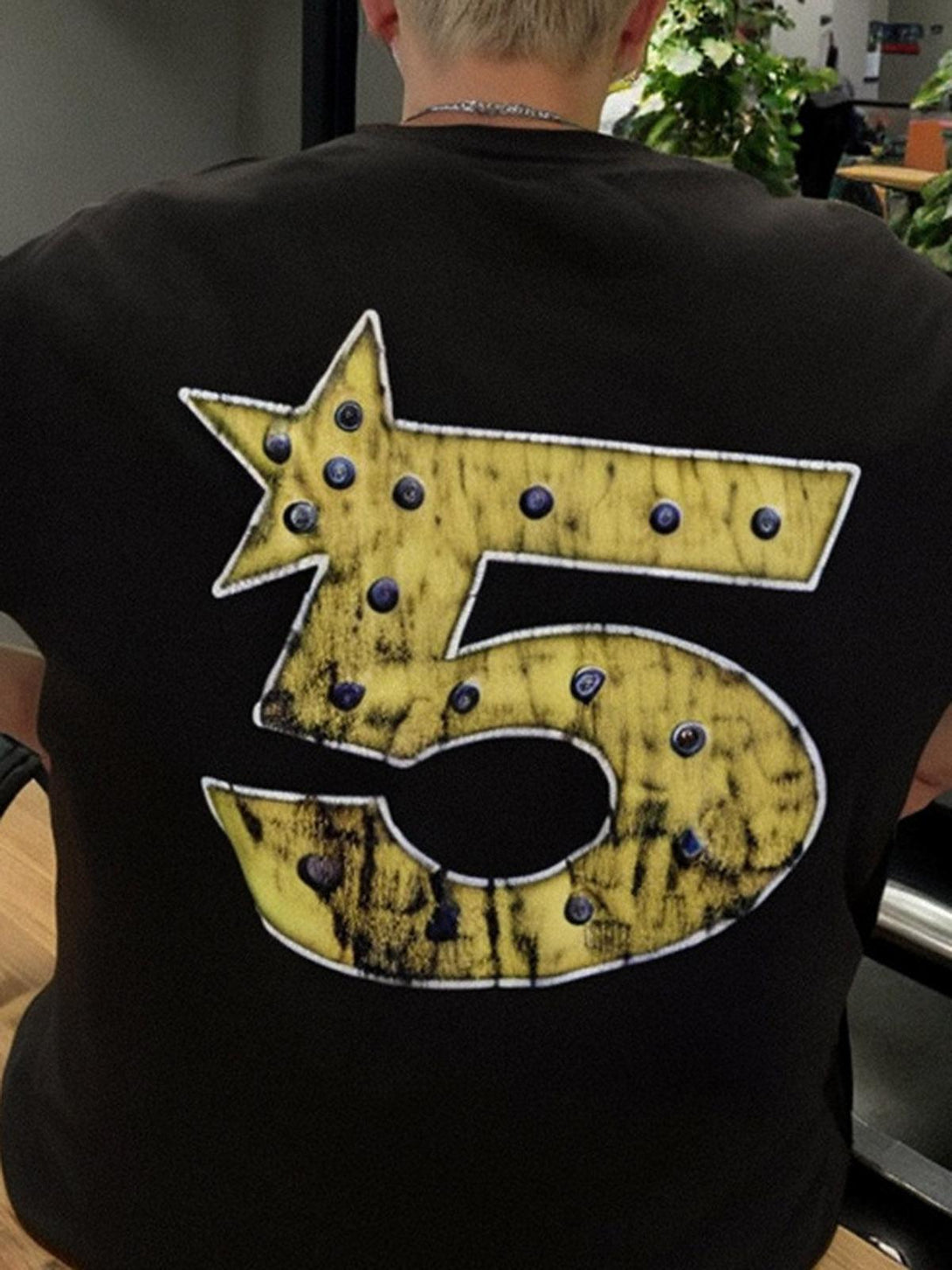 Back view of TALISHKO T-shirt showcasing bold yellow number five with star design.
