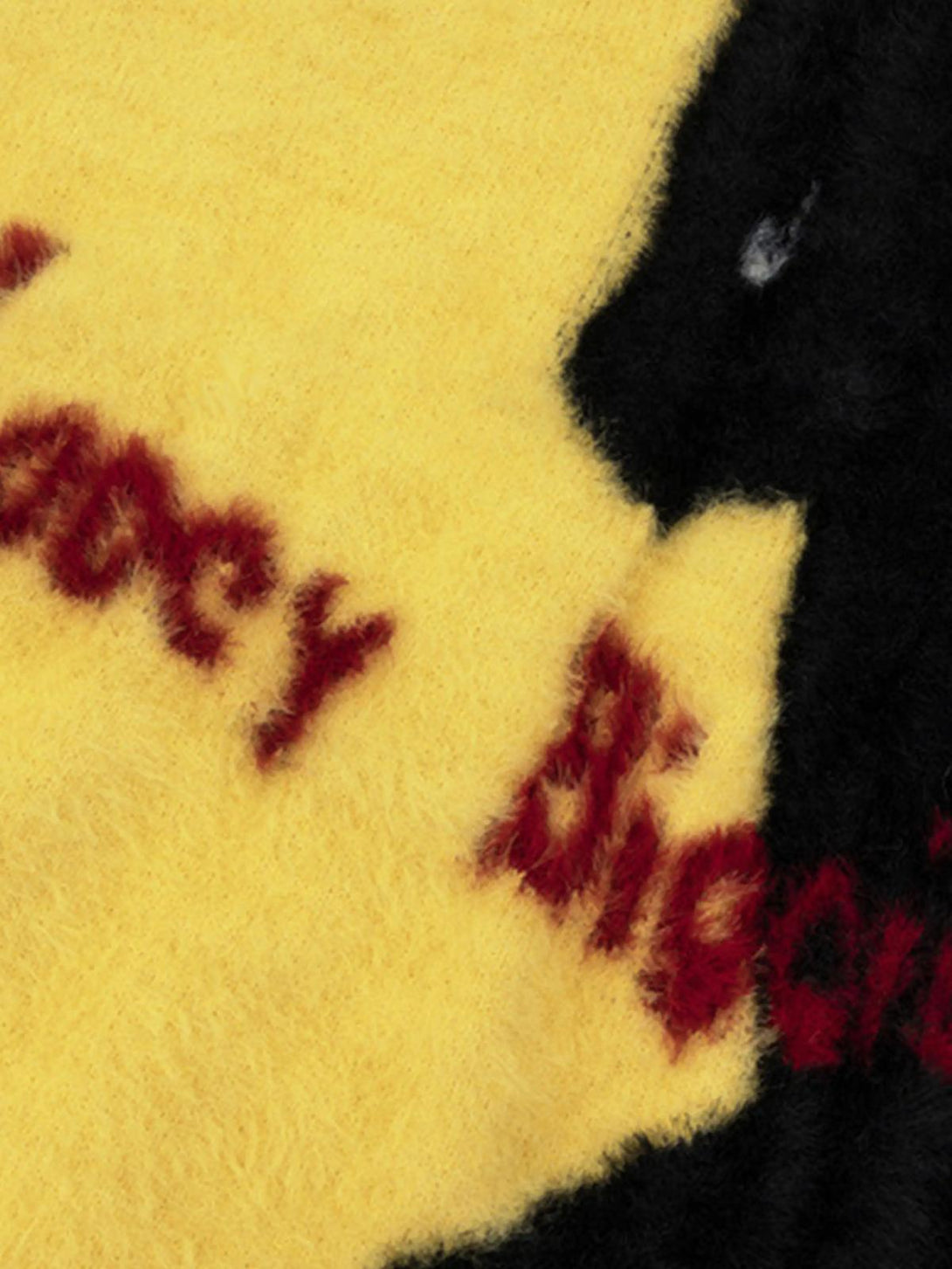 A fuzzy yellow sweater by TALISHKO with a playful black cat silhouette and red lettering.