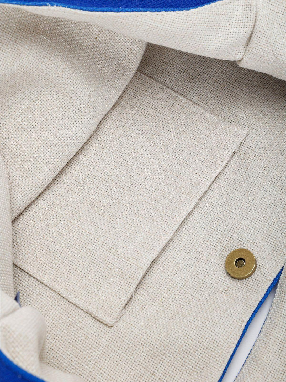 Detailed interior view of TALISHKO canvas bag, highlighting natural fabric and magnetic clasp.