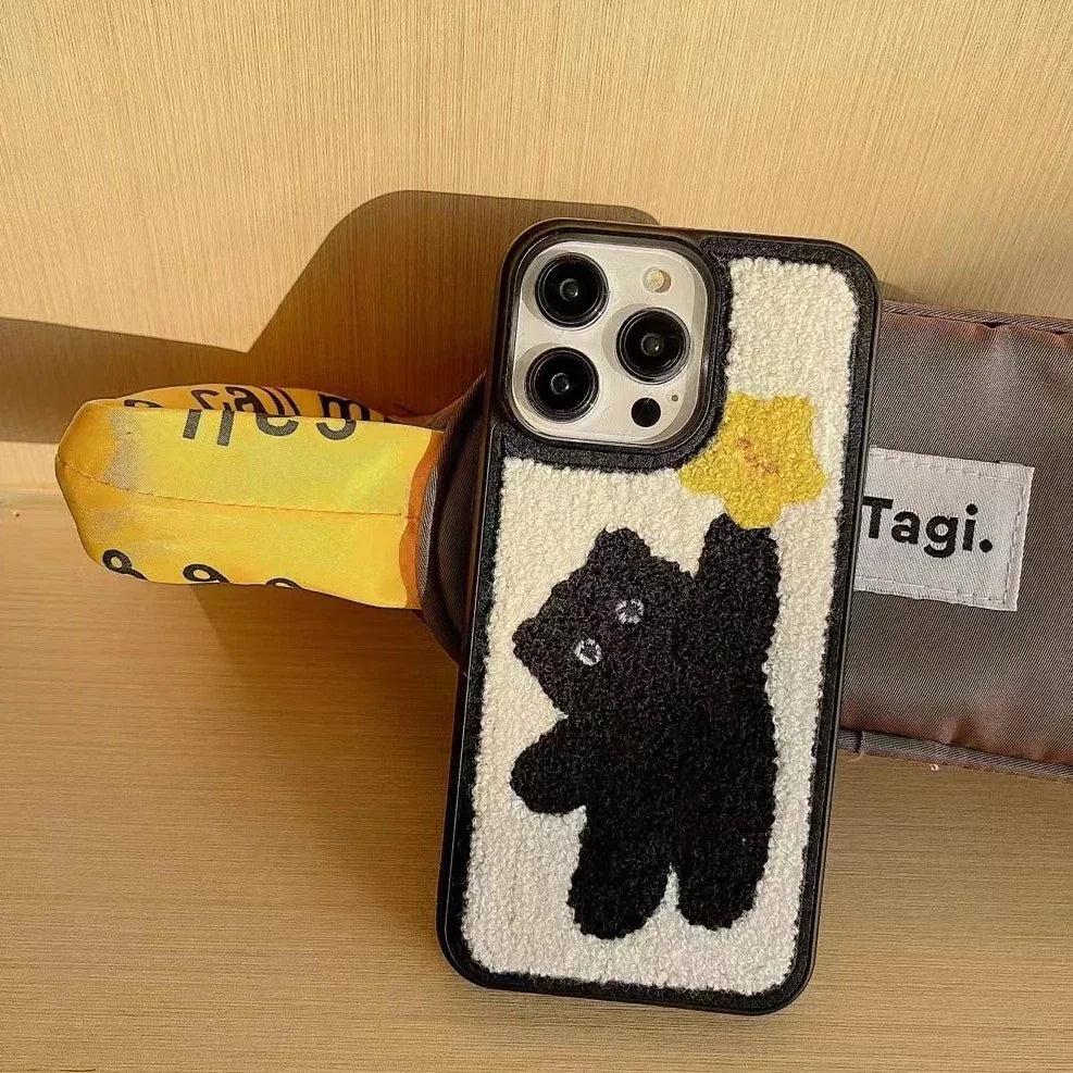 A TALISHKO Korean plush iPhone case featuring a cute black bear design with a yellow star.