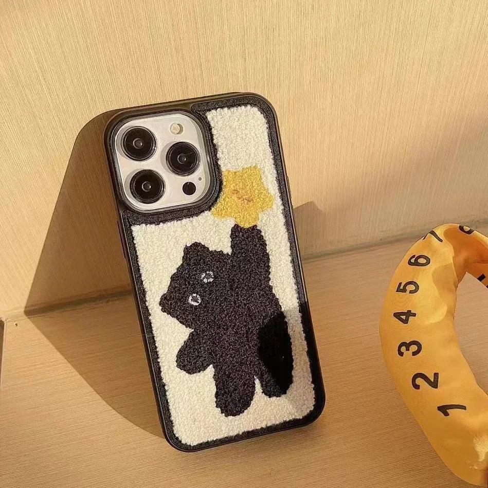 TALISHKO Korean plush iPhone case featuring a playful black bear reaching for a yellow star.