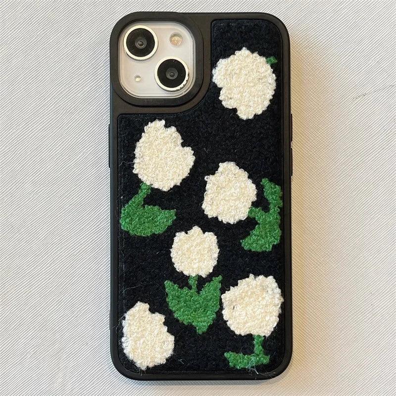 TALISHKO iPhone case with plush white floral design on a dark background, showcasing texture.