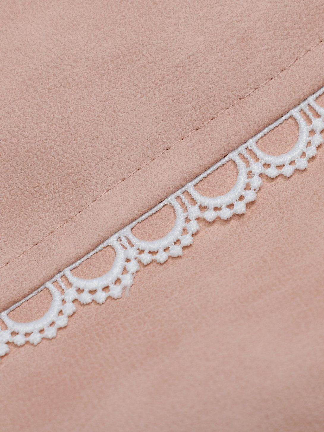 A detailed look at TALISHKO's pink faux leather jacket showcasing intricate lace trim design.