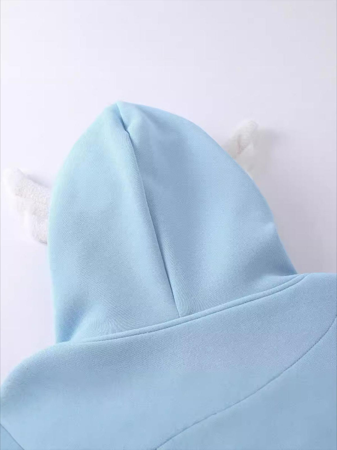 Light blue TALISHKO hoodie with playful ear details, showcasing a whimsical back view.