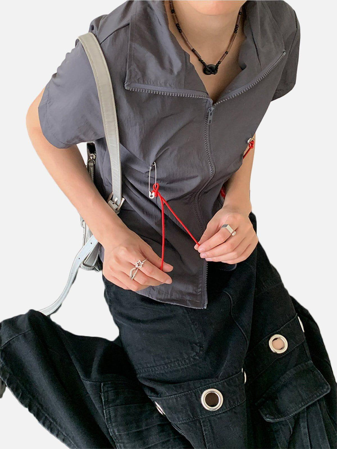 Model in gray TALISHKO tee with red lanyard details, paired with black pants for a chic look.