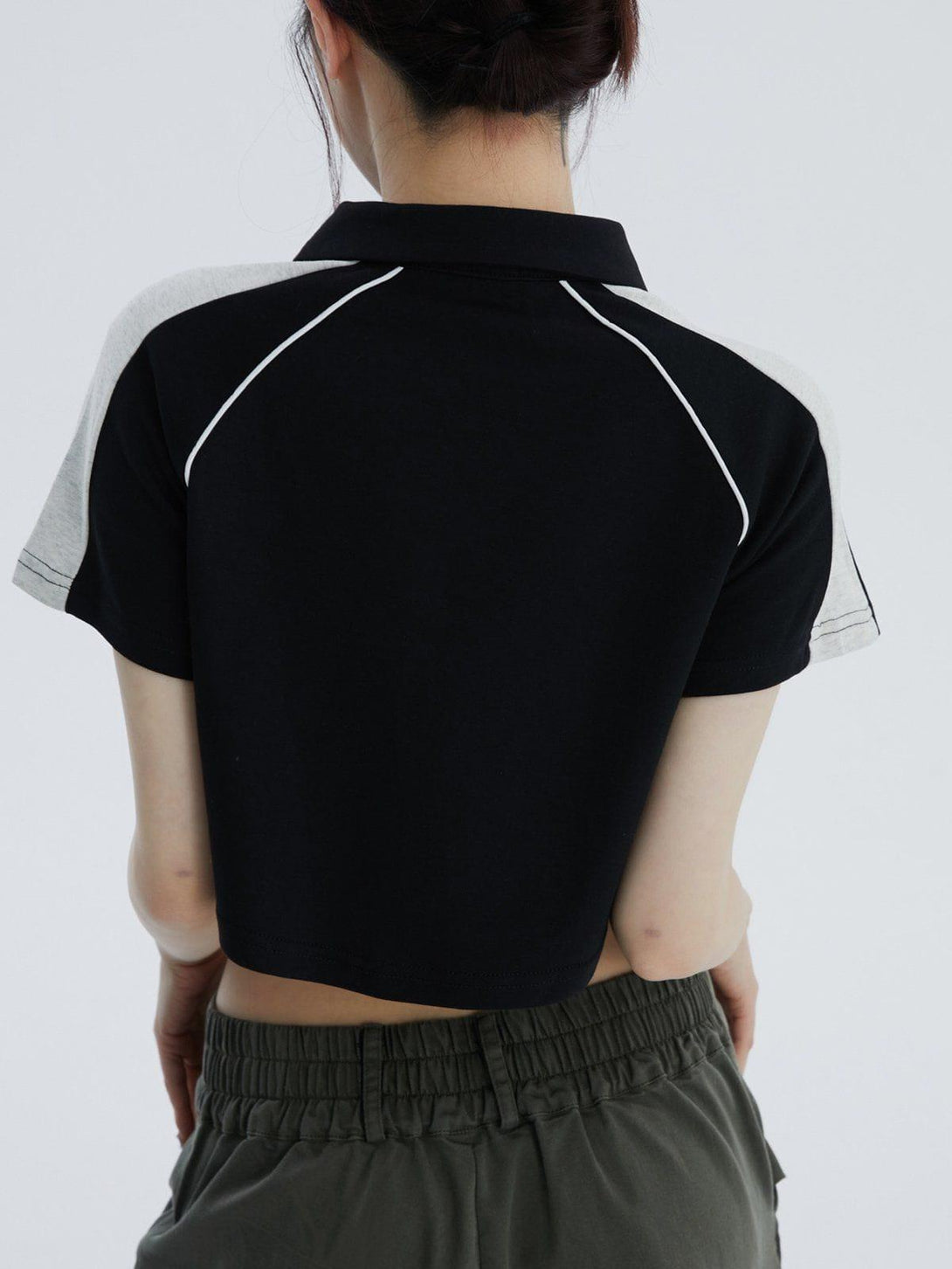 Back view of a TALISHKO colorblock tee with a lapel design, highlighting casual summer vibes.