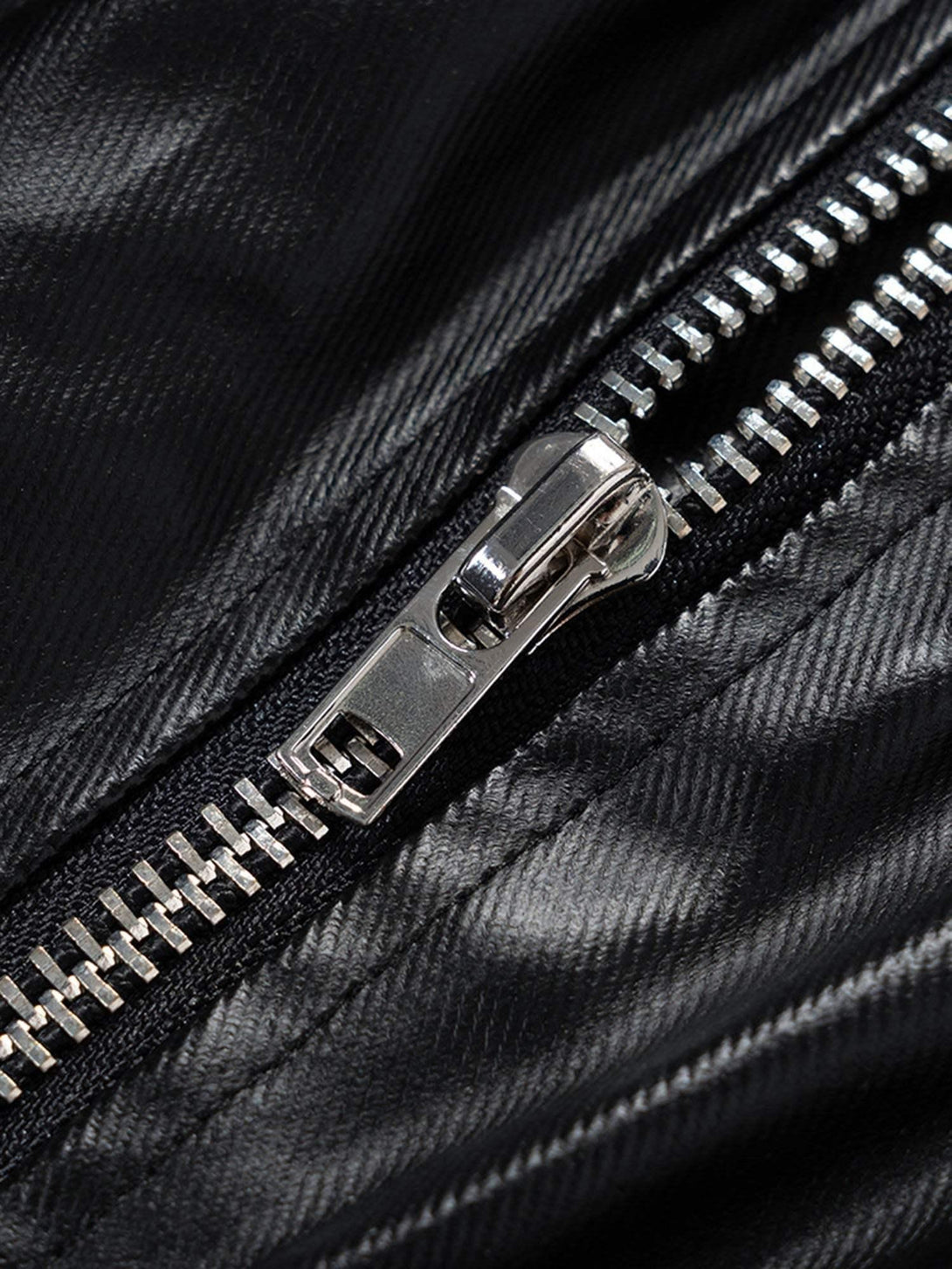 A detailed view of the zipper on TALISHKO's layered wide-leg flared pants.