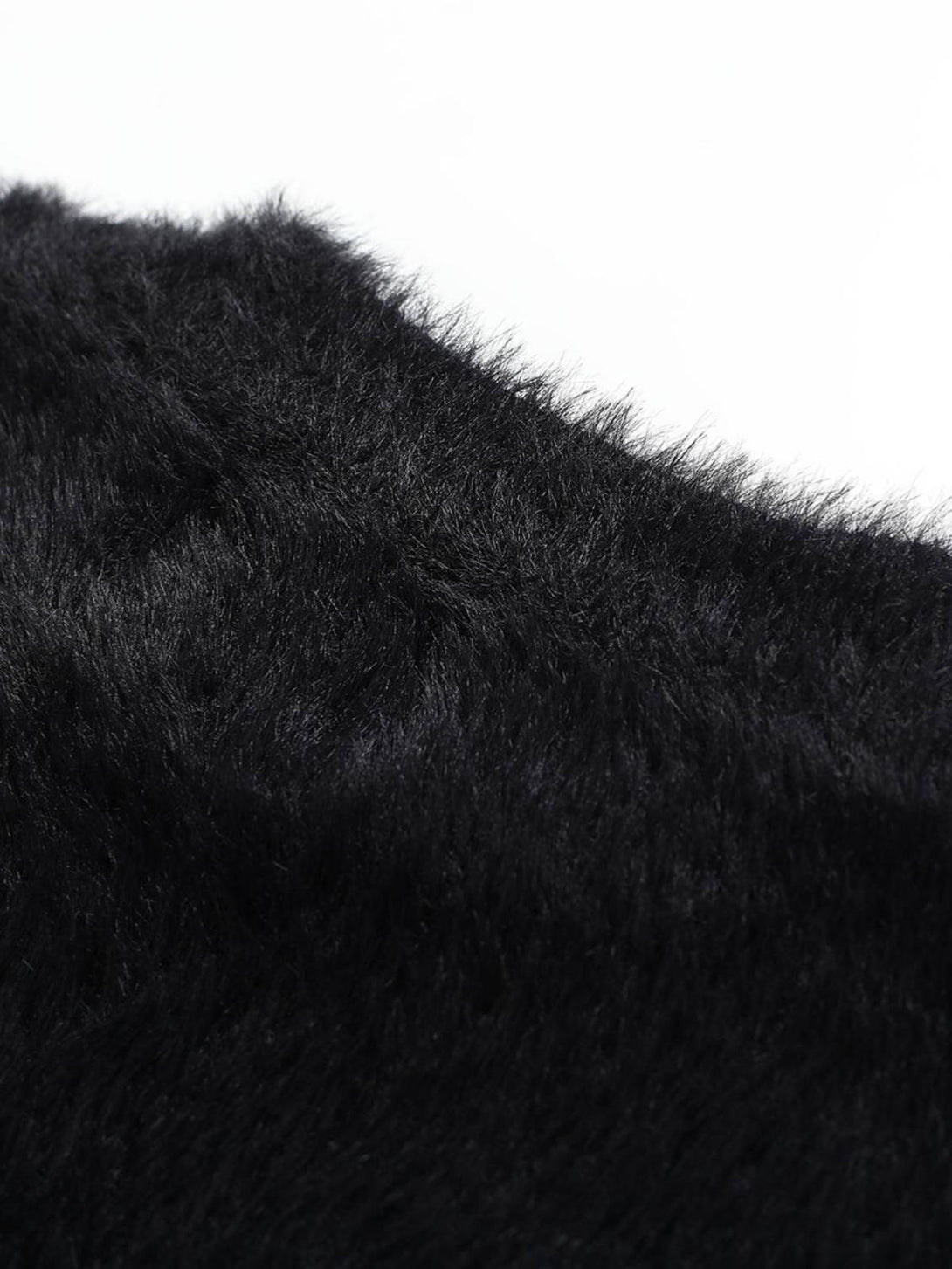 A close-up of TALISHKO's plush velvet sweater, highlighting its luxurious black texture.