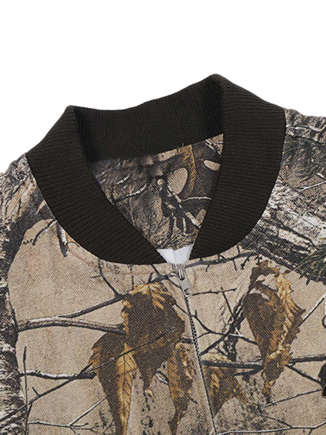 Detailed fabric and stitching of TALISHKO bomber jacket in leaf camouflage pattern.