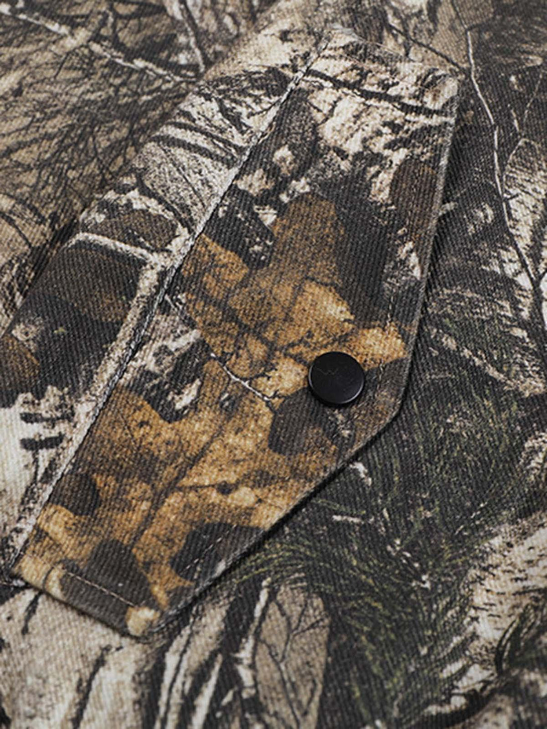 A close-up of the textured leaf camouflage pattern on a TALISHKO bomber jacket.
