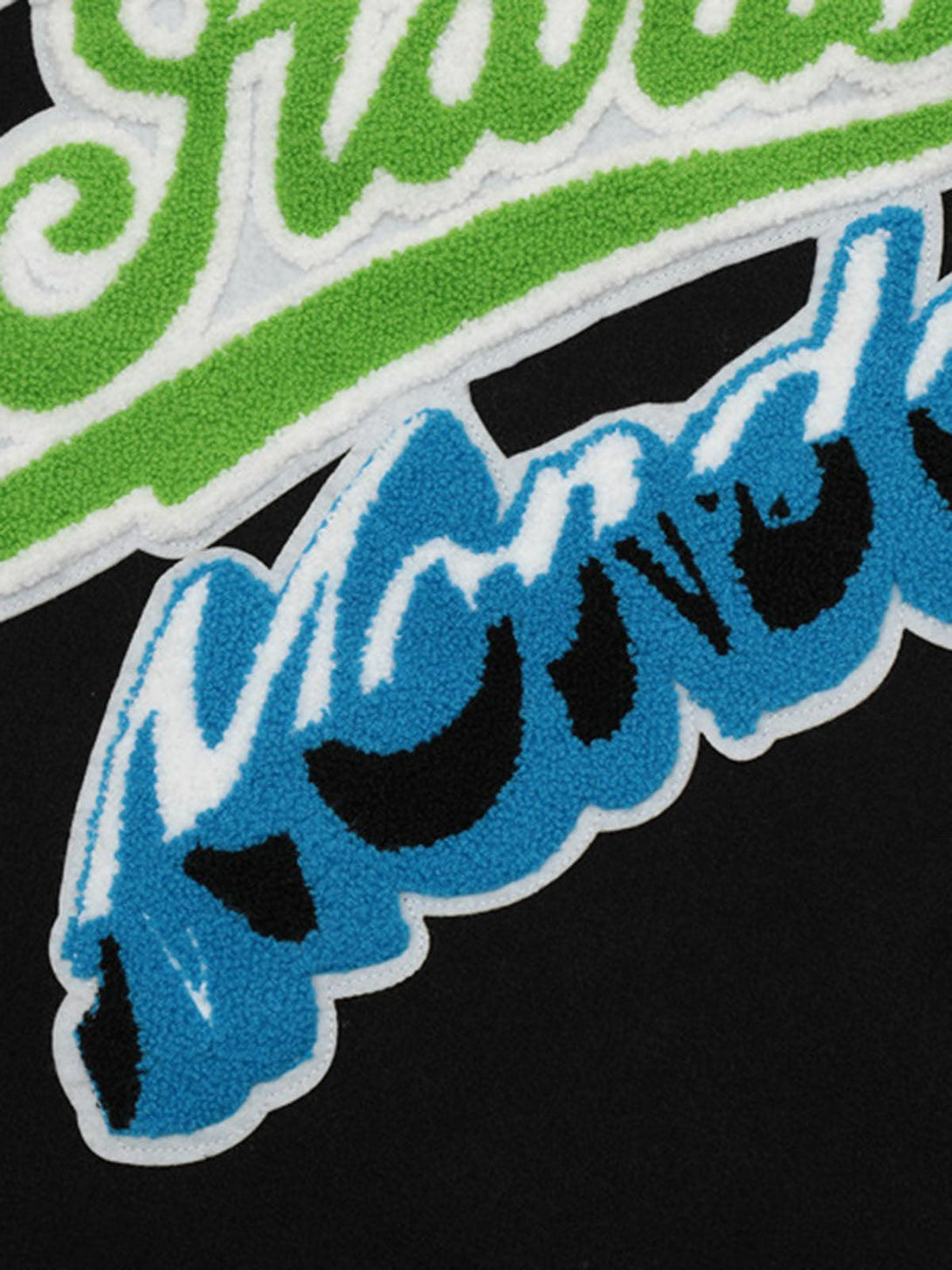 Intricate look at TALISHKO's colorful embroidered lettering on quilted bomber jacket.