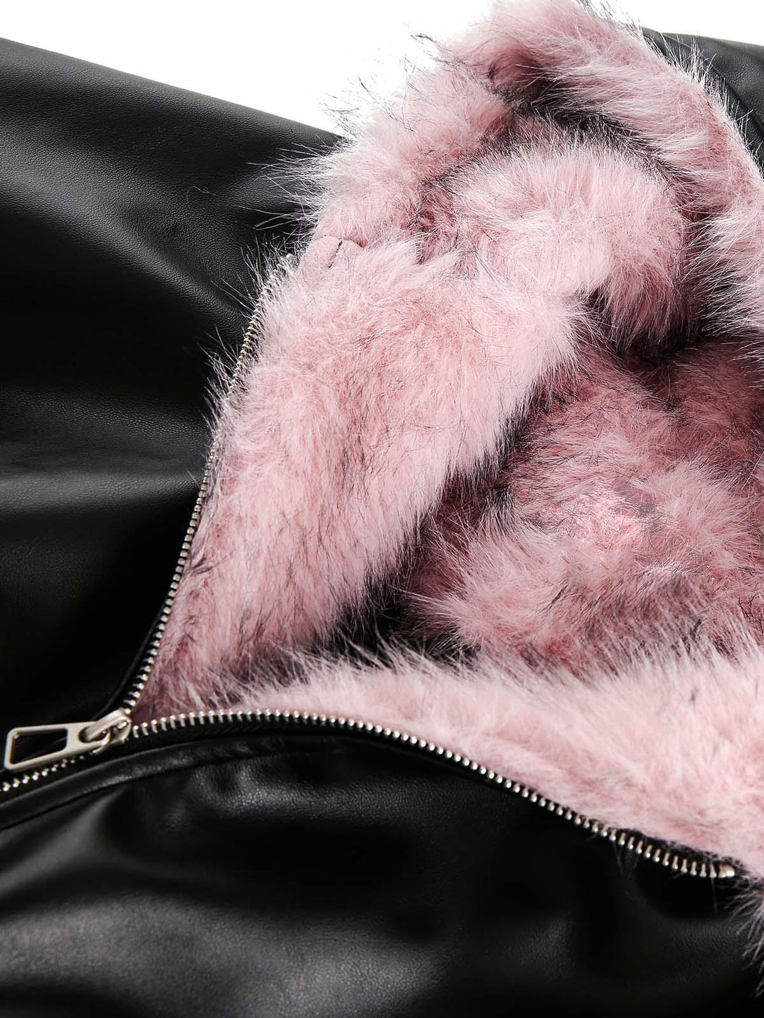 Zoomed-in detail of TALISHKO's black leather jacket with soft pink fur lining and zipper.