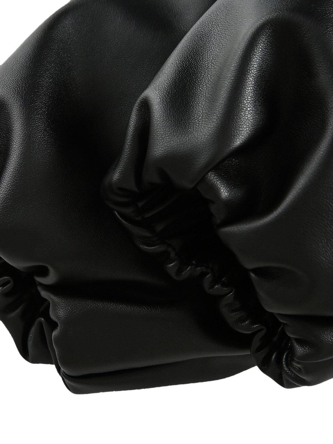 A detailed view of TALISHKO's black leather jacket texture and stitching.