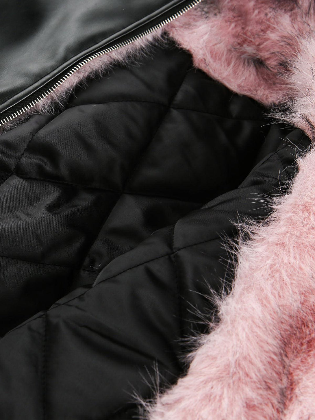 Intricate look at TALISHKO's quilted black interior with plush pink fur lining detail.